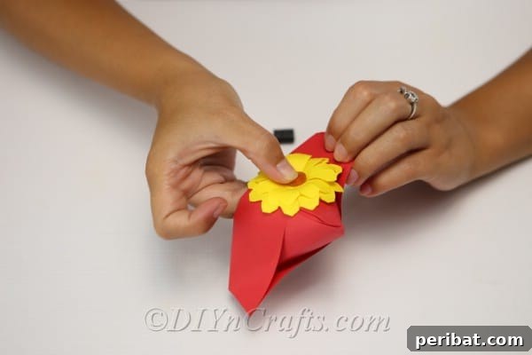 Adding a flower to the hat for the scarecrow craft
