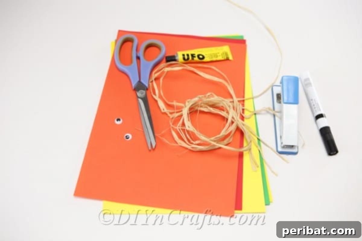 Supplies needed for making a paper scarecrow craft sitting on a white surface