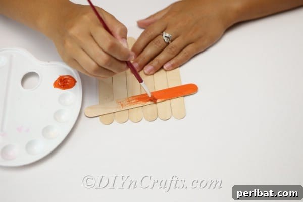 Creating the hat on the how to make a scarecrow out of craft sticks tutorial