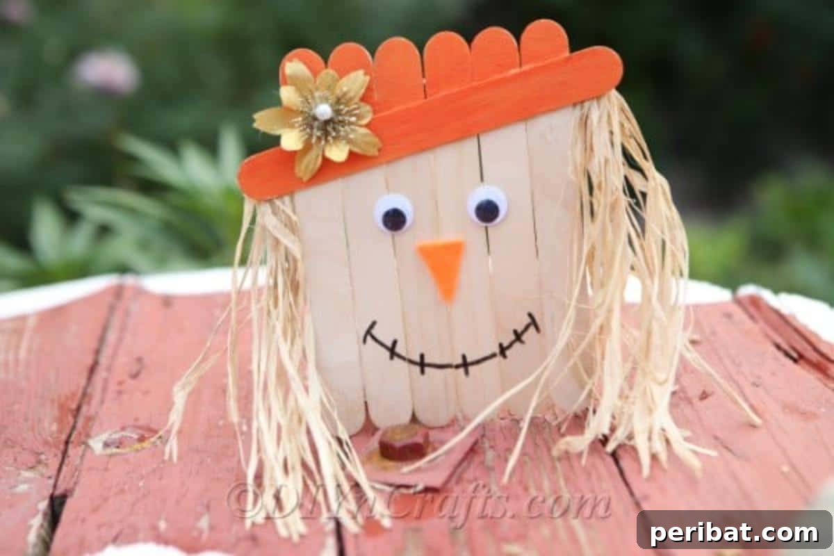 A completed scarecrow craft sitting on a wooden table outside