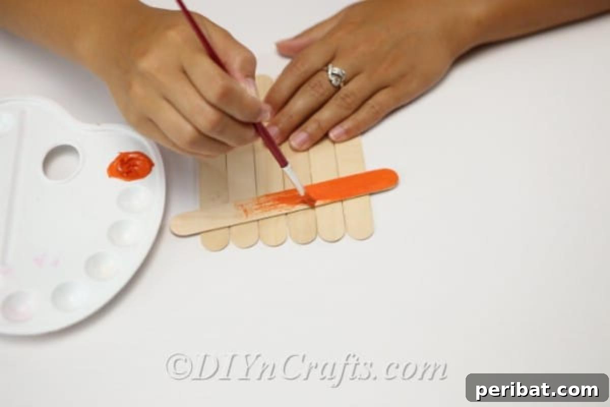 Creating the hat on the how to make a scarecrow out of craft sticks tutorial