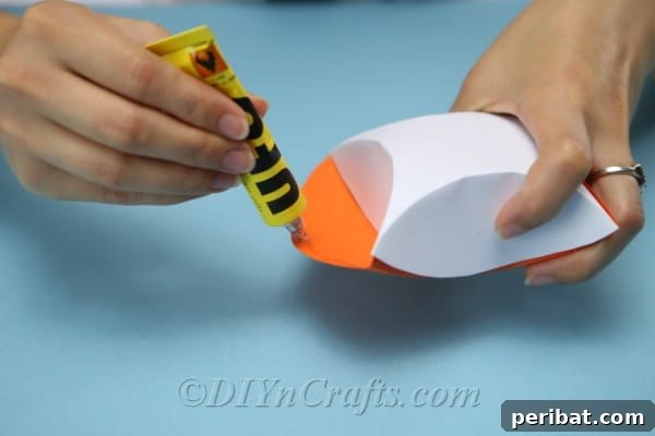Craft Charming Pumpkin Gift Boxes 12 Gluing the two folded cardstock pieces together to form the main structure of the treat box