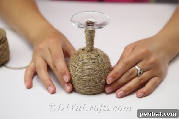 Rustic Glow: DIY Wine Glass Candle Holder 11 The wine glass completely adorned with twine from rim to stem, showcasing the rustic texture.