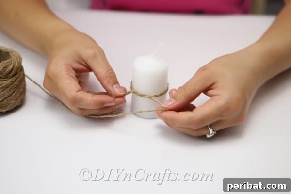 Rustic Glow: DIY Wine Glass Candle Holder 15 Tying a small twine bow around the pillar candle, adding a cohesive rustic element.