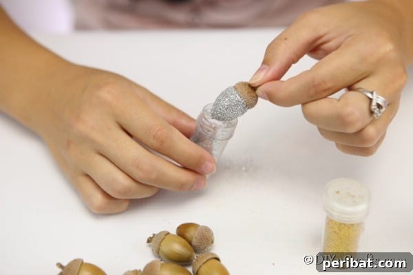 Sparkling Acorn Creations for Autumn Displays 12 Dipping acorns into loose glitter