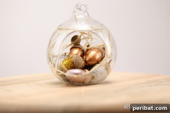 Sparkling Acorn Creations for Autumn Displays 13 Glitter acorn decoration as a harvest decor in a glass globe