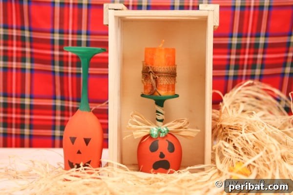 Two wine glass pumpkins displayed in and by a wooden box with a red plaid background