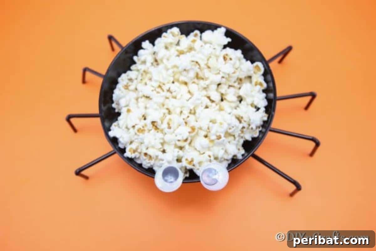 Halloween Spider Web Treat Bowl DIY 5 Overhead picture of halloween spider bowl sitting on orange surface