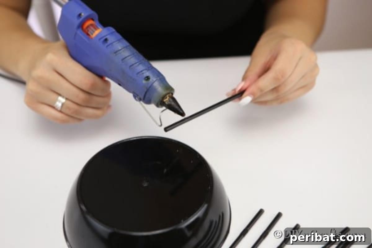 Halloween Spider Web Treat Bowl DIY 7 Gluing straws to bottom of halloween spider bowl