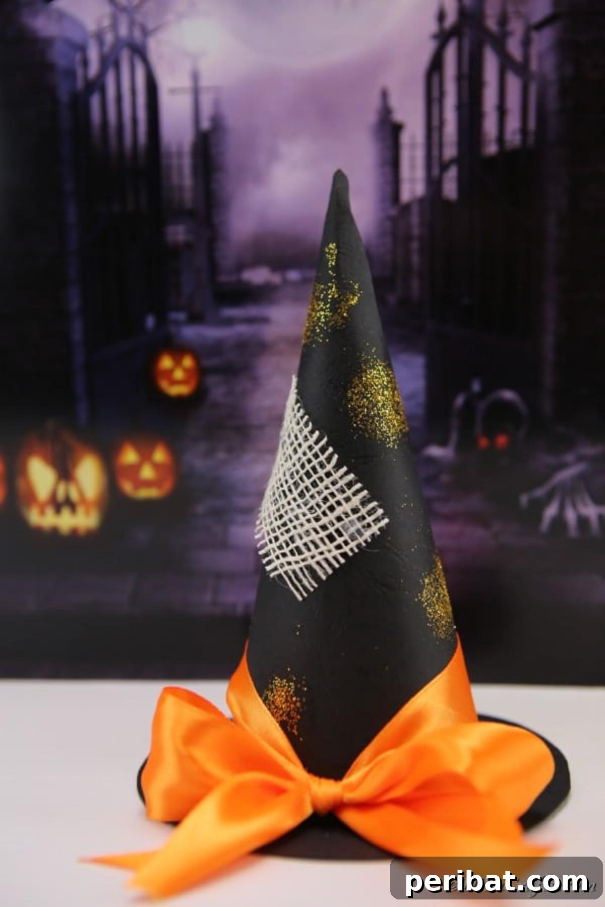 Bewitching DIY Witch Hat for Halloween 4 Black witch hat craft sitting on a white table with purple Halloween banner behind, showcasing material flexibility