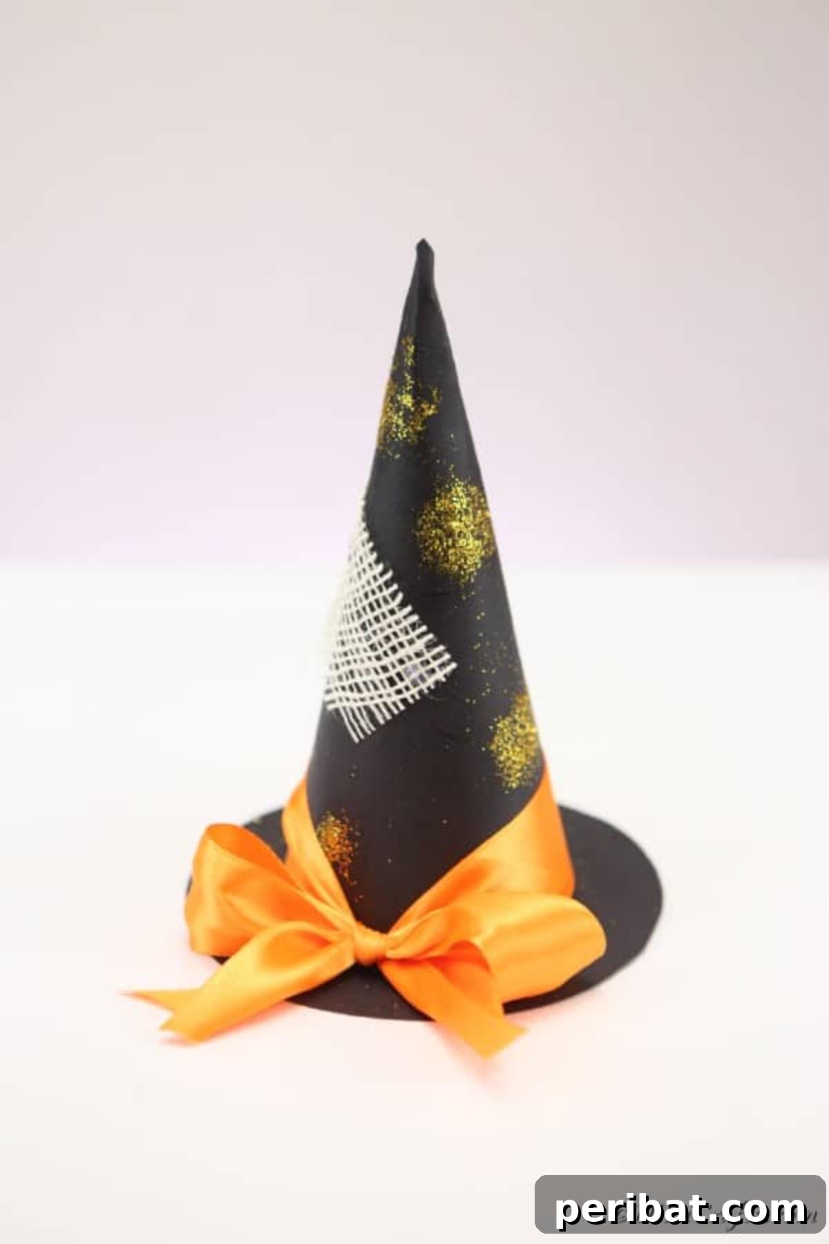Bewitching DIY Witch Hat for Halloween 10 Completed witch hat Halloween decoration craft sitting on a white table with a gray background