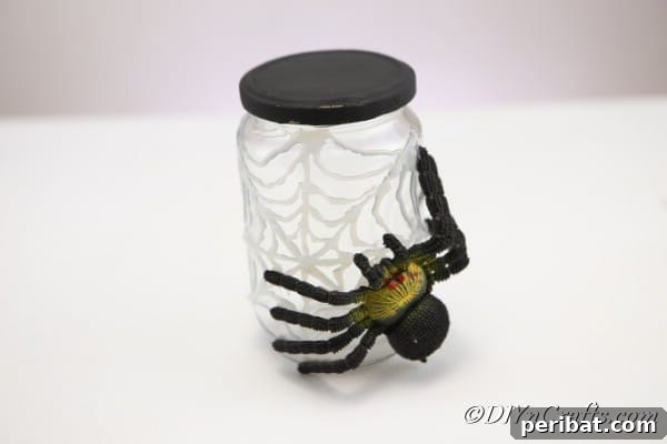 Completed halloween spider web craft jar
