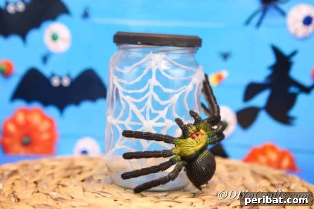 A halloween spider web jar on a brown surface with blue halloween themed background