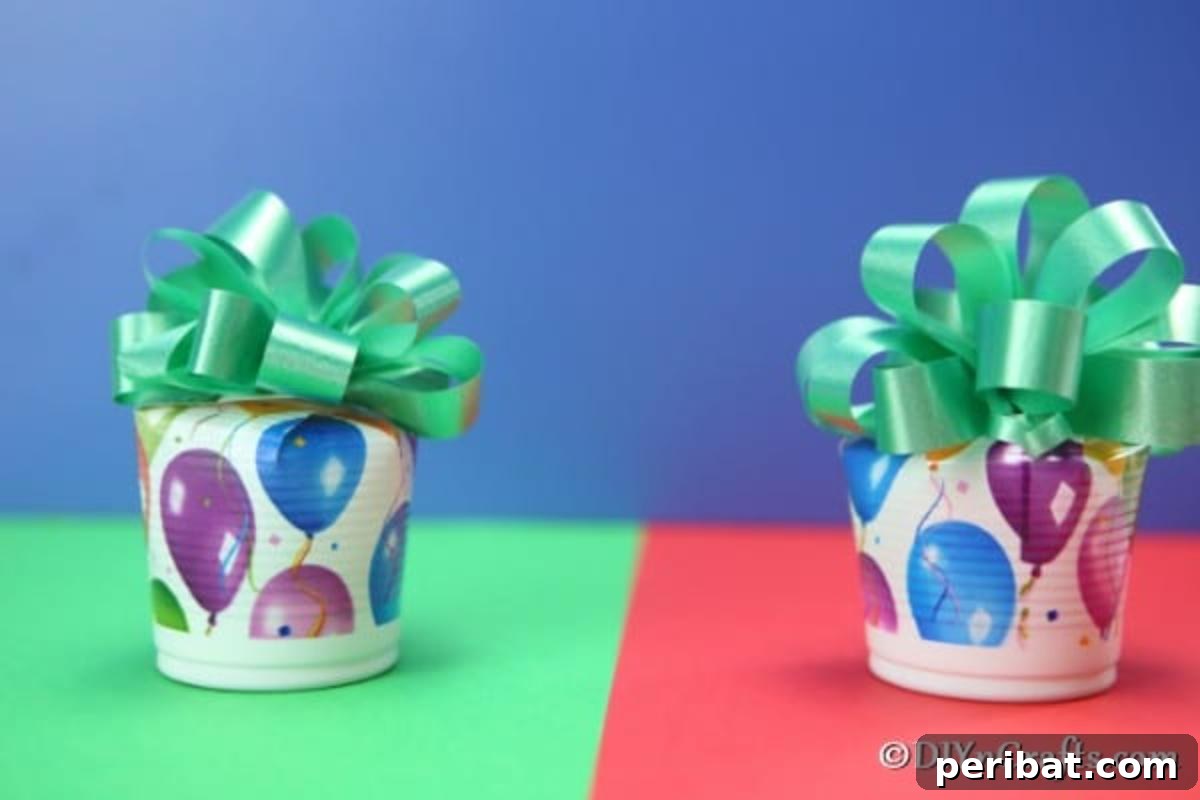 An up close picture of completed party cup cookie boxes sitting on a green and red surface