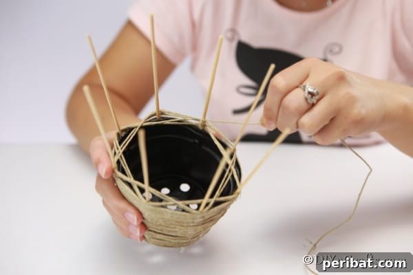 Craft a Charming Rustic Basket 15 Weaving thread in and out of dowels to create woven basket