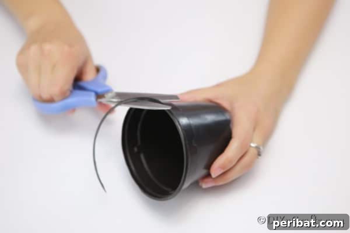 Craft a Charming Rustic Basket 7 Cutting the lip off the top of your flower pot for the woven basket