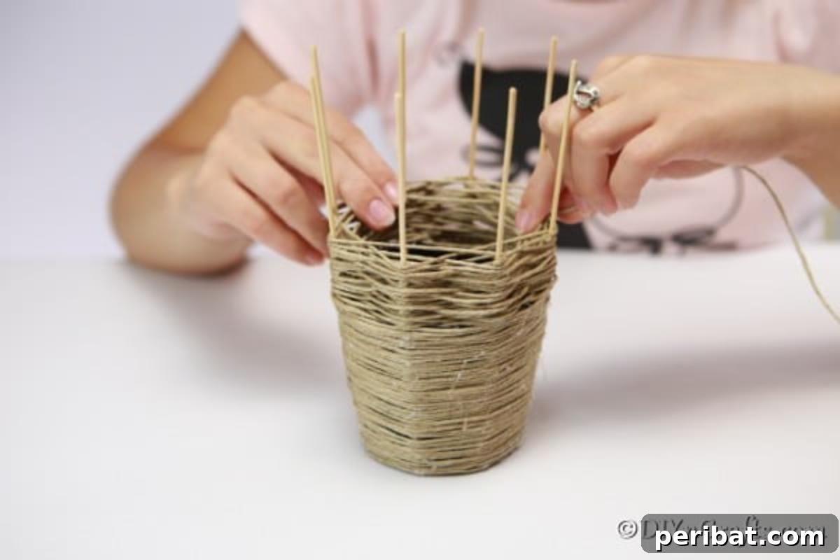 Craft a Charming Rustic Basket 9 Wrapping the thread around the dowels for the woven basket