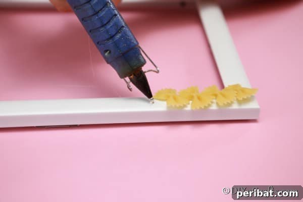 Gluing pasta to the outside of the picture frame