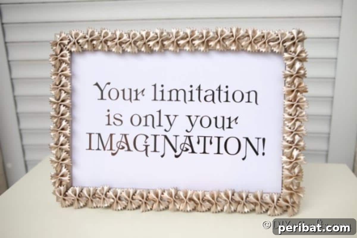 A gold sprayed macaroni art picture frame on a counter