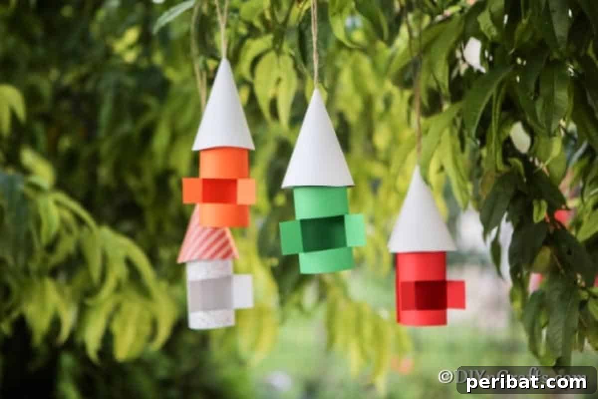 Enchanting Paper Gnome Homes for Your Garden 3 A collection of colorful paper gnome houses displayed in a tree, showcasing variety