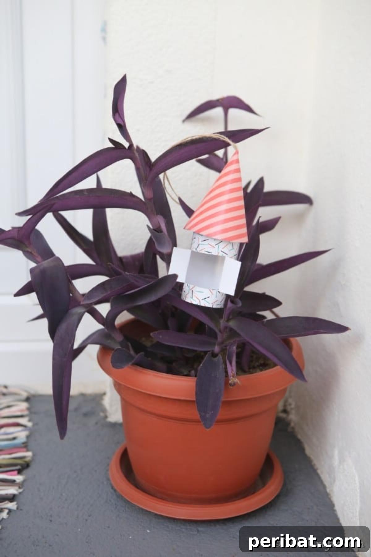 Enchanting Paper Gnome Homes for Your Garden 4 A paper gnome house sitting quaintly in a potted plant, demonstrating versatile placement