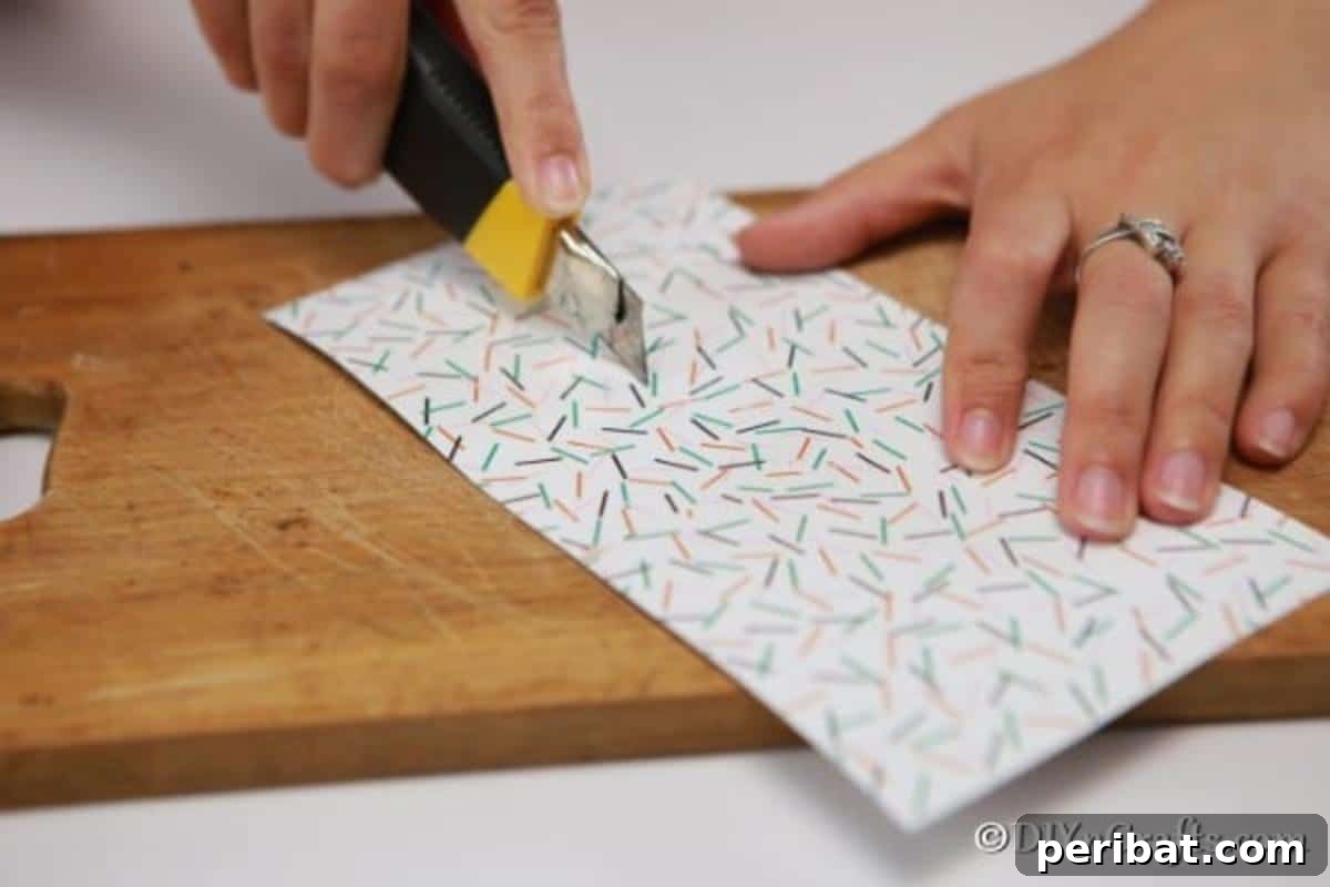 Enchanting Paper Gnome Homes for Your Garden 8 Cutting paper for the base of a gnome house, demonstrating the door cut