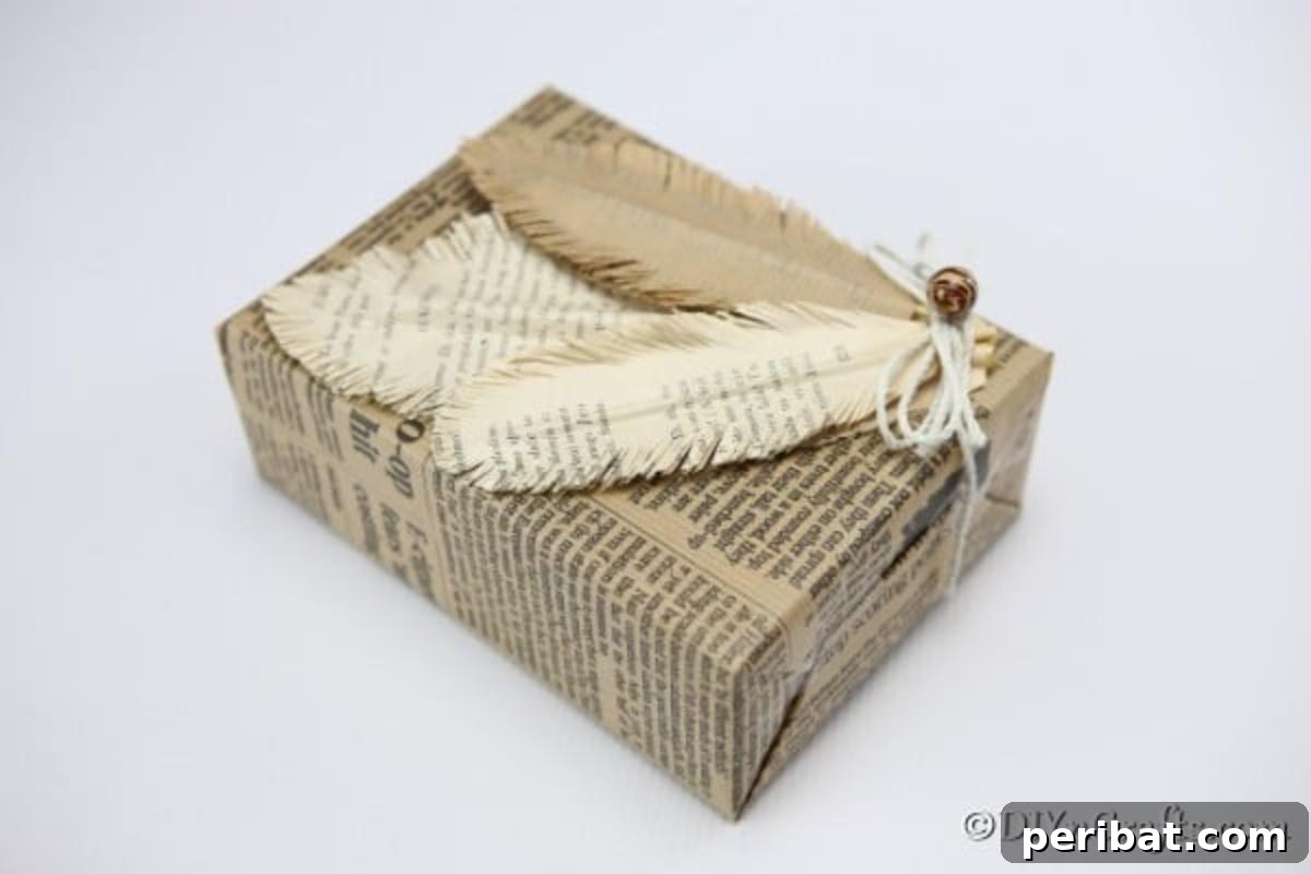 A beautifully finished decorative feather crafted from old book pages, elegantly displayed on a newspaper-covered package.