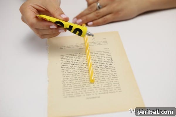 Measuring the size of the feather against a straw