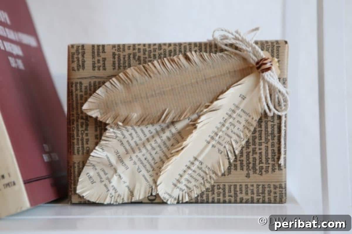 Decorative feathers made from book pages gracefully adorning a newsprint-wrapped box, showcasing upcycled decor.