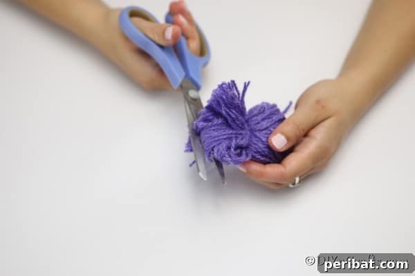 Cutting the ends of yarn to create a flower