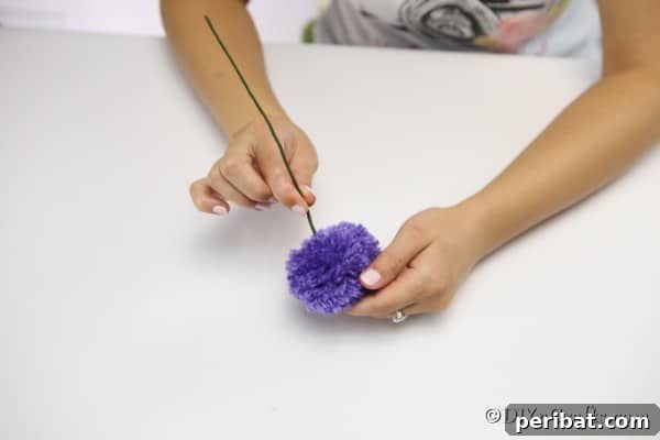 Attaching the wire stem to the yarn flowers
