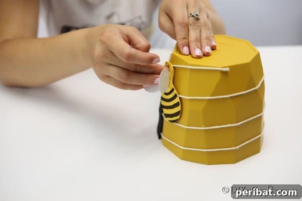 Whimsical Bee Garden Planter 21 Gluing a bee to the side of the flower pot garden decoration