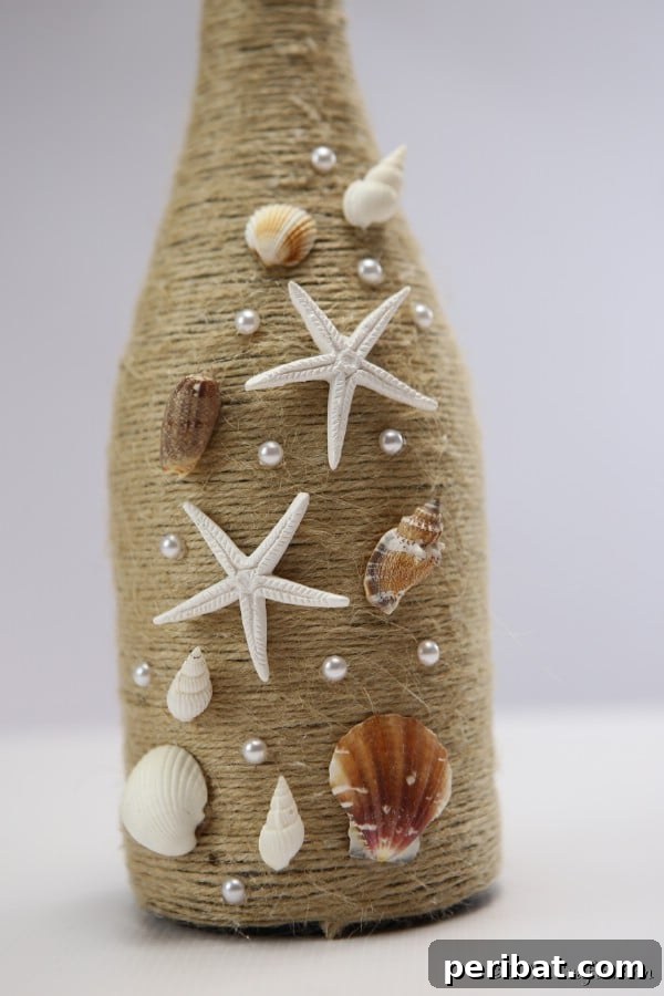 Coastal Rustic Wine Bottle Charm 16 Up close picture of the shells attached to a nautical wine bottle decor piece