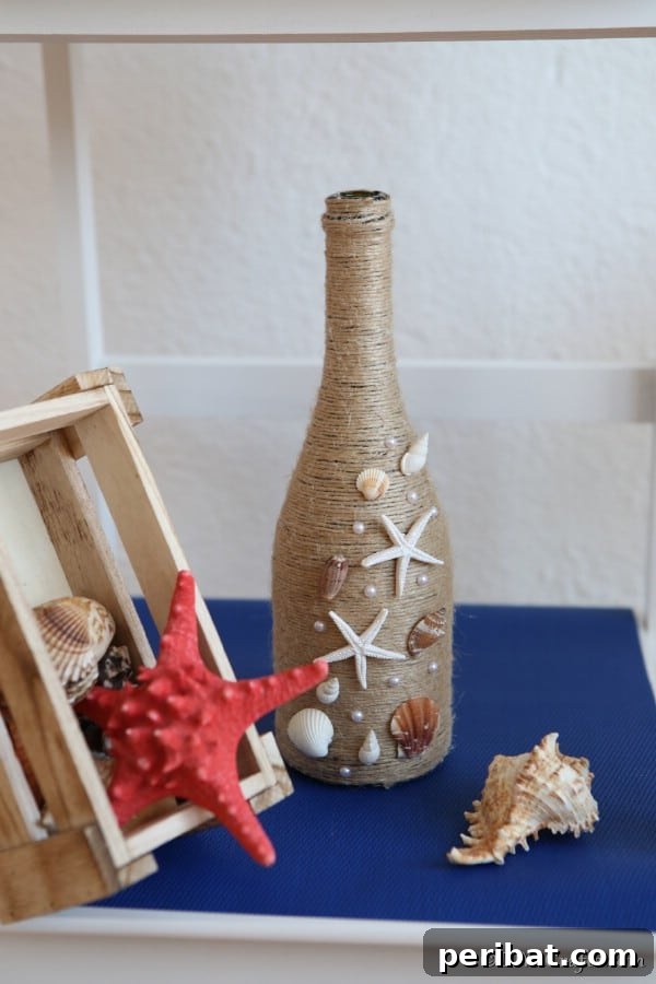 Coastal Rustic Wine Bottle Charm 17 Nautical wine bottle decor on a blue shelf with other seashells