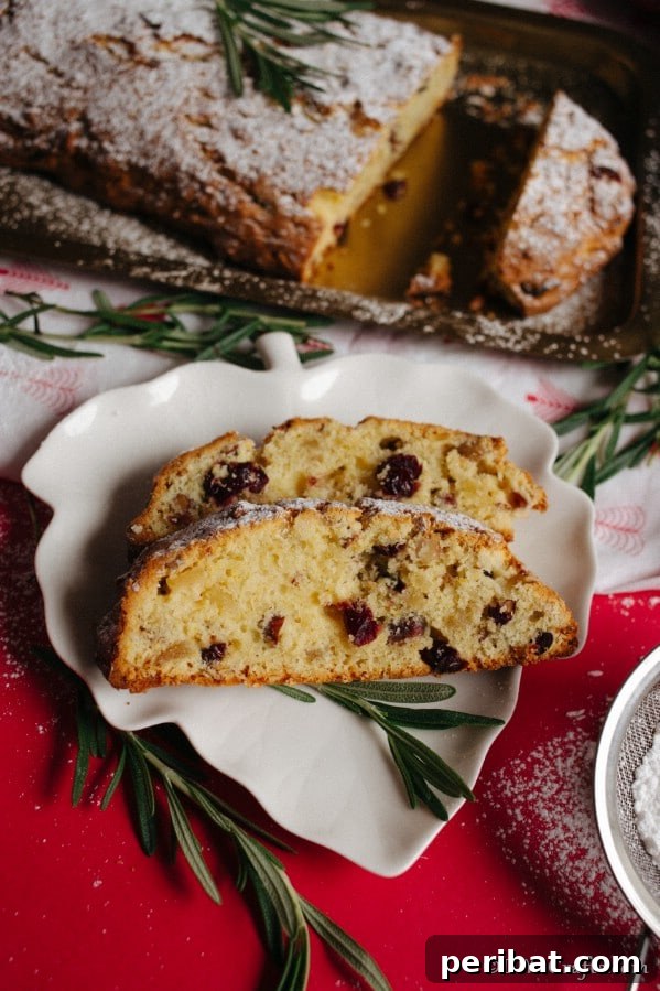 German Christmas Stollen Festive Bread Recipe 12 Overhead picture of sliced Christmas Stollen on a plate in front of the baking sheet