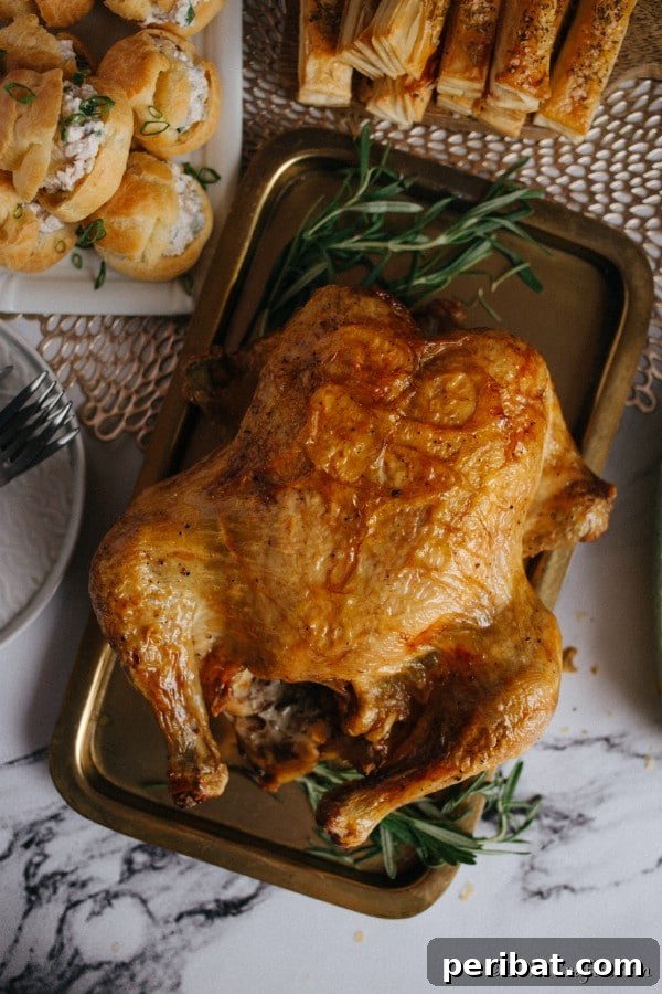 Golden Rosemary Roasted Chicken 11 A large roasted rosemary chicken on a baking sheet