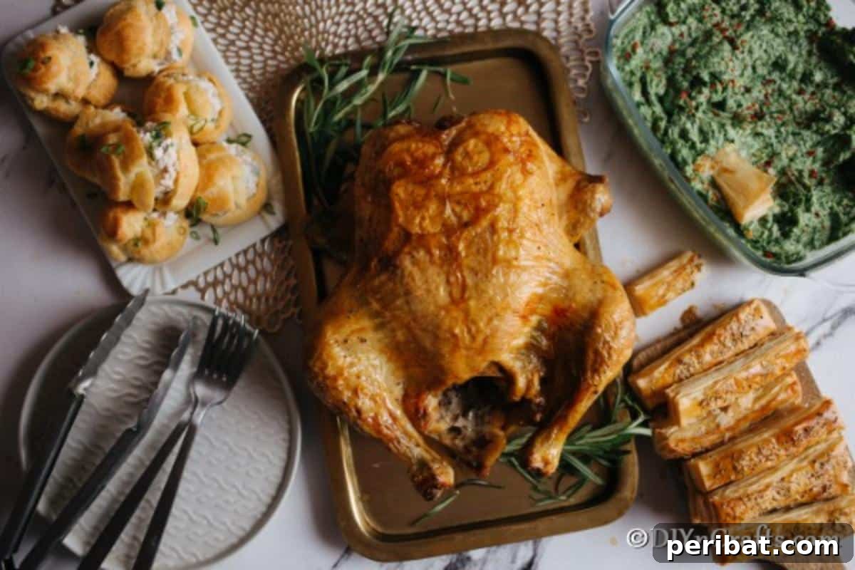 Golden Rosemary Roasted Chicken 3 Overhead picture of a roasted rosemary chicken recipe with all of the sides on the table next to it