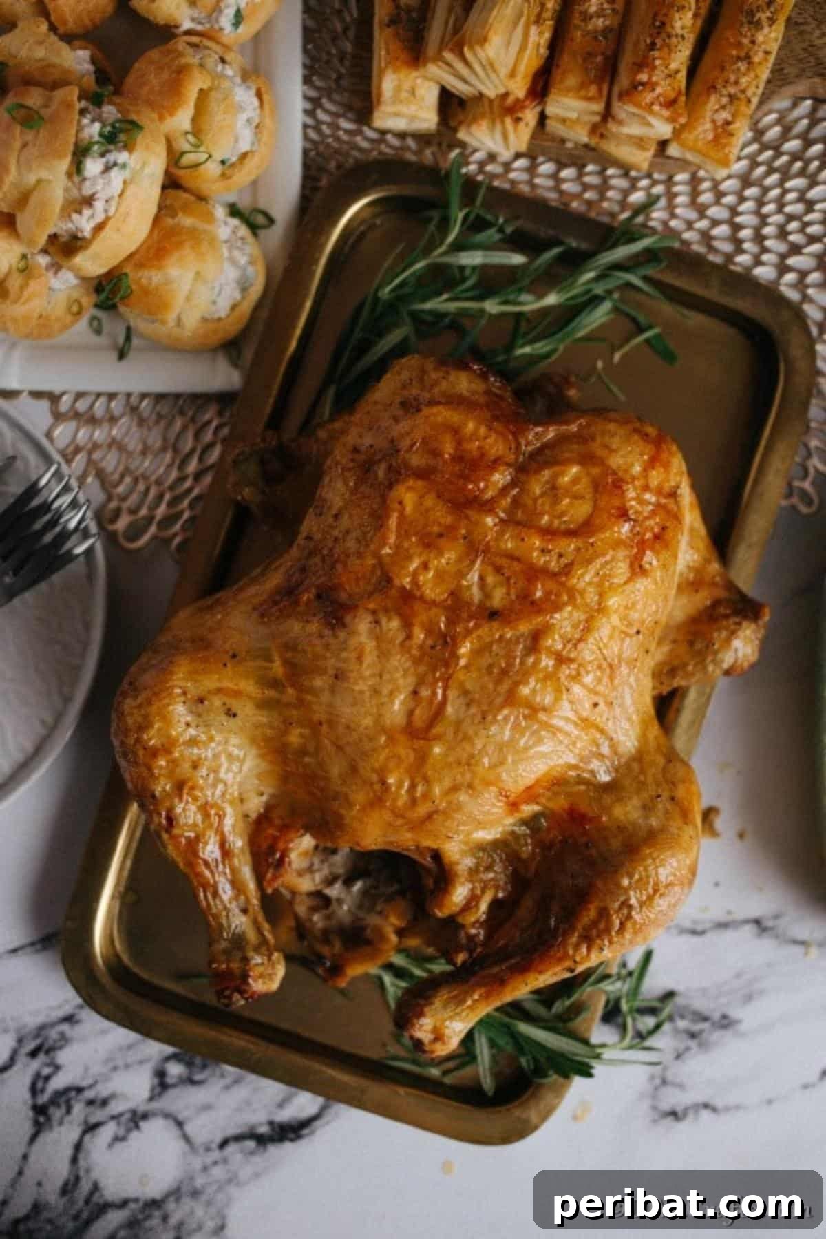 Golden Rosemary Roasted Chicken 4 A large roasted rosemary chicken on a baking sheet