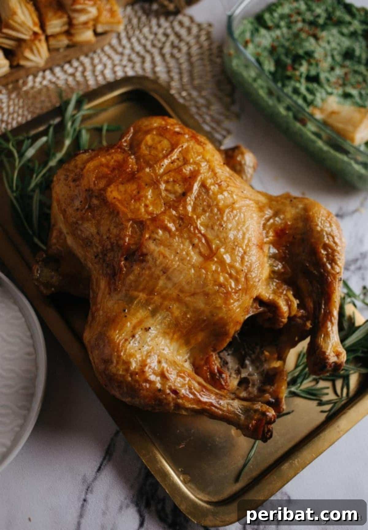 Golden Rosemary Roasted Chicken 8 Overhead picture of a roasted chicken on a baking dish