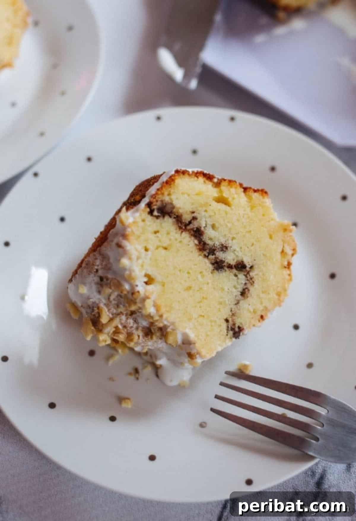 Sweet Surprise Sock It To Me Cake 8 A single slice of sock it to me cake on a white and black polka dot cake