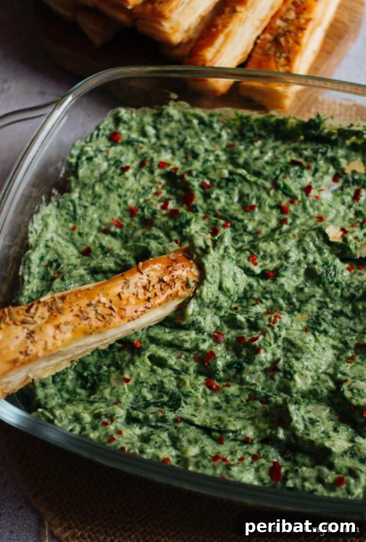 Up close picture of a large bowl filled with hot spinach dip