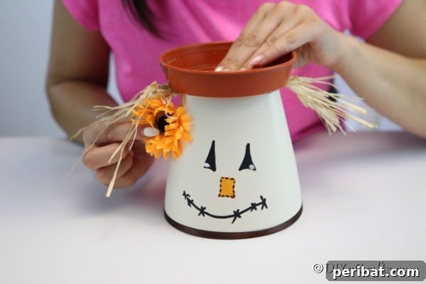 Whimsical Scarecrow Pot Lantern 18 Securing the plastic plate on top of the diy scarecrow