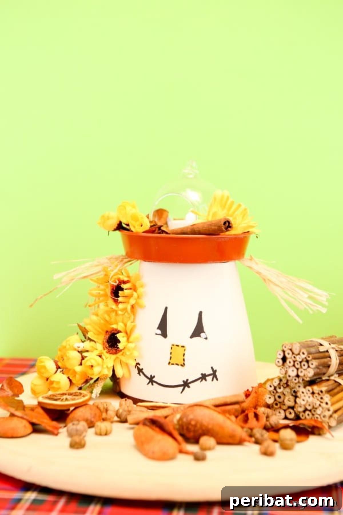 Whimsical Scarecrow Pot Lantern 6 An adorable DIY scarecrow clay pot lantern, featuring a cheerful face and natural hay accents, positioned against a soft light green background, highlighting its handmade charm and versatility.