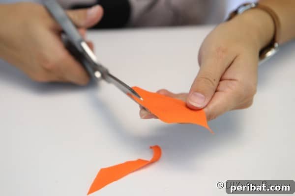Carefully tracing fabric pieces to match the segments of the Styrofoam ball, ensuring proper fit for the pumpkin ornament