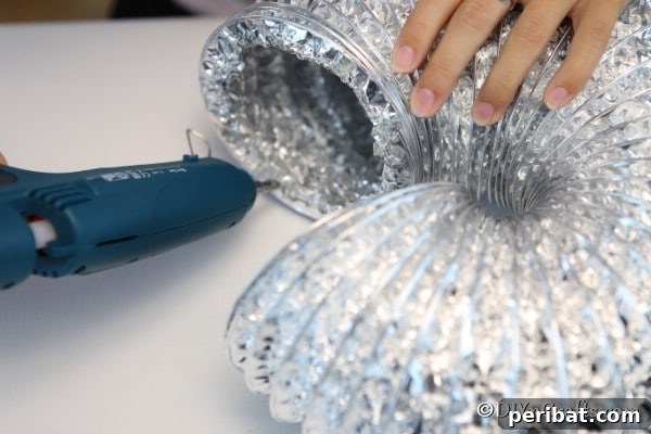 Easy DIY Dryer Vent Pumpkins Video Tutorial Included 13 Gluing ends of dryer vent together for pumpkin decor