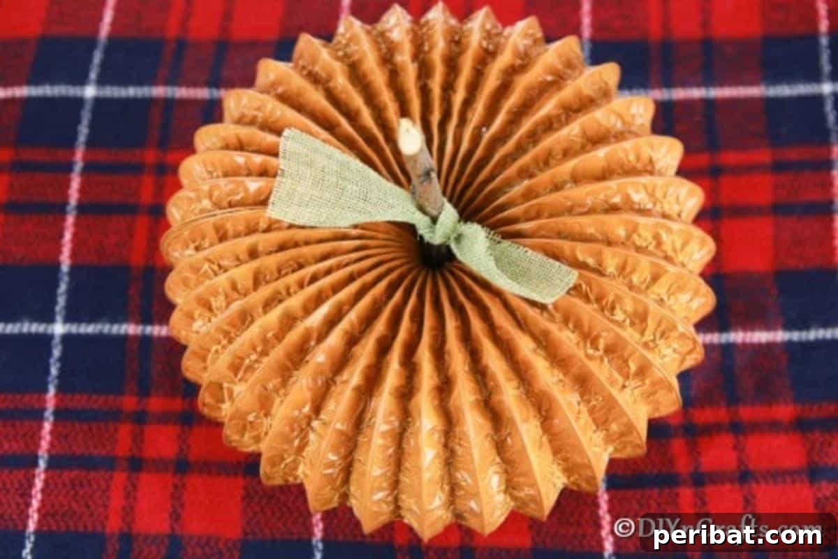 Easy DIY Dryer Vent Pumpkins Video Tutorial Included 3 A finished dryer vent pumpkin decor sitting on red plaid fabric