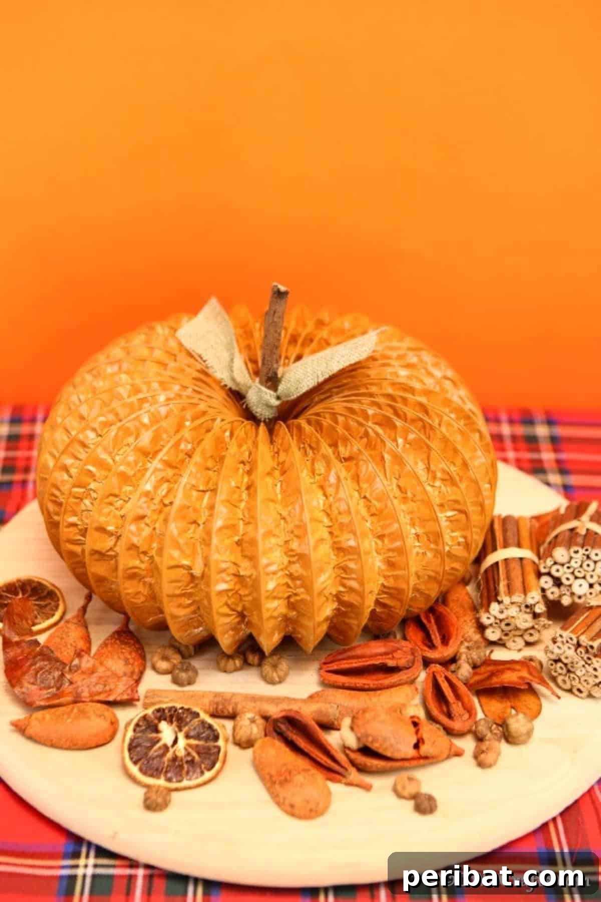 Easy DIY Dryer Vent Pumpkins Video Tutorial Included 4 Pumpkin decor sitting on a table with other fall items in front of an orange background
