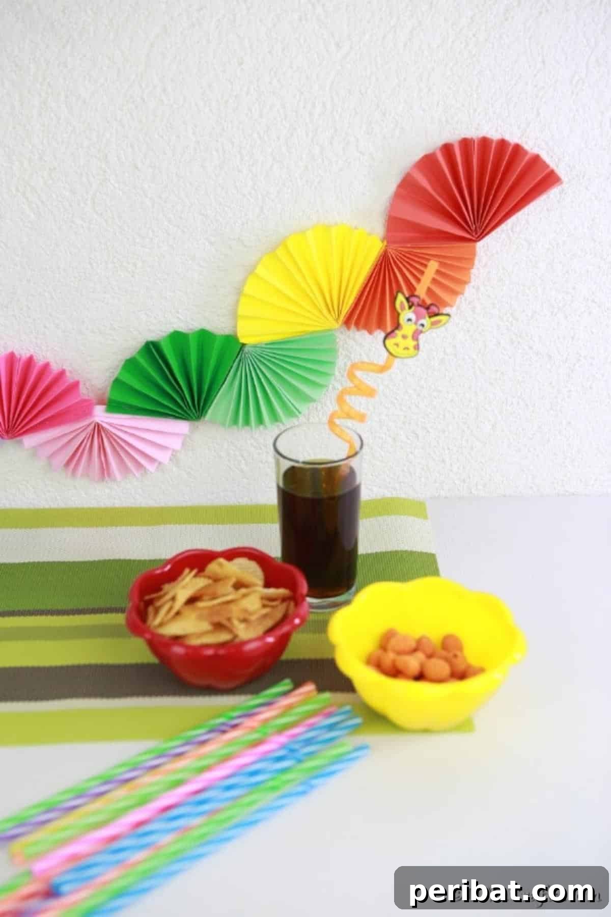 A simple yet elegant paper fan party garland beautifully hanging behind a bustling buffet table, adding a festive touch to the event.