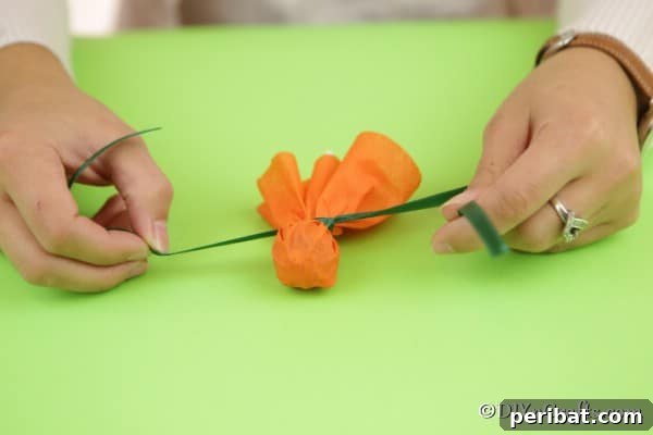 Tying a ribbon around a lollipop to create a ghost
