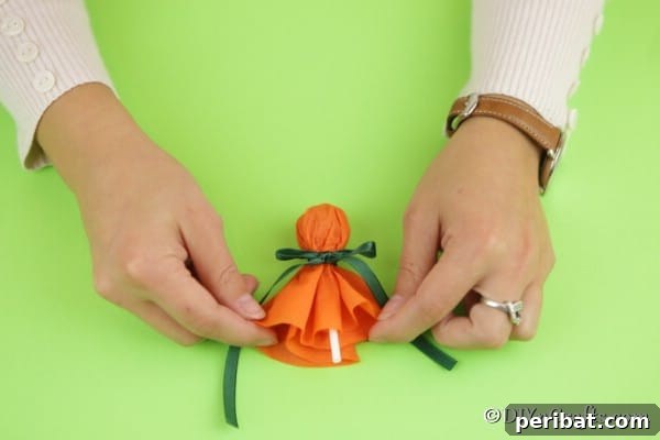 Tying the ribbon and fluffing the skirt of the ghost lollipop